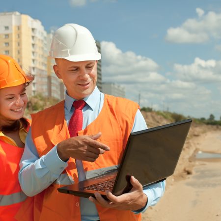 White-collar workers wearing protective helmet works on the building site